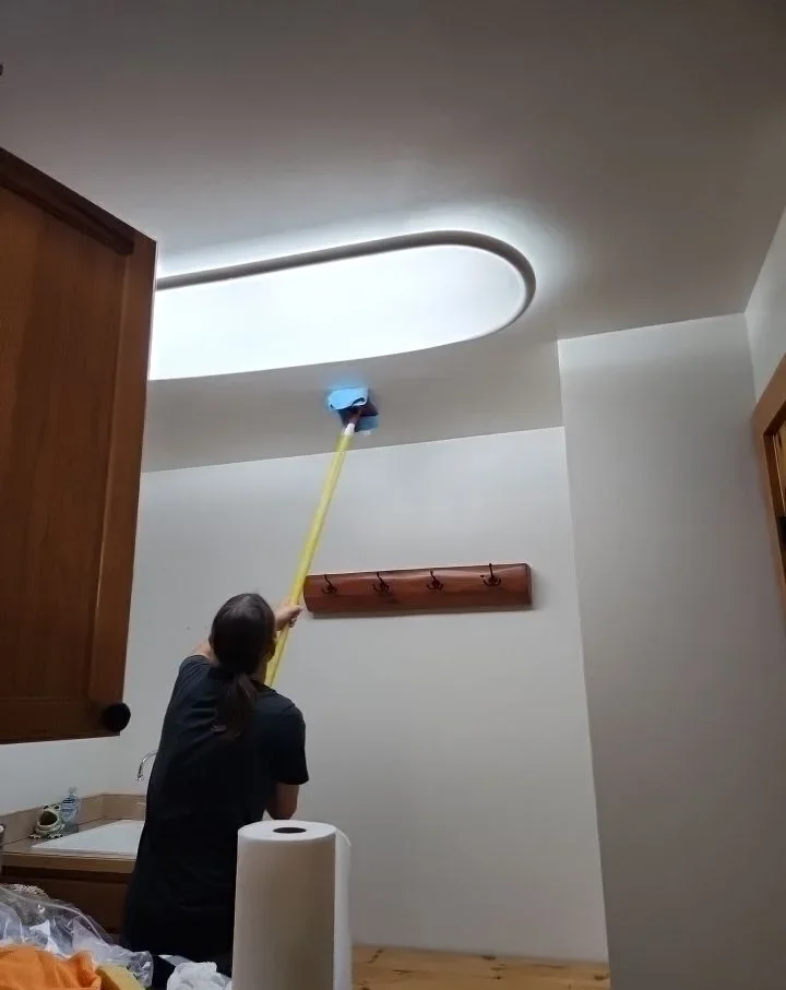 SWAT technician dusting a ceiling during a whole-home deep clean
